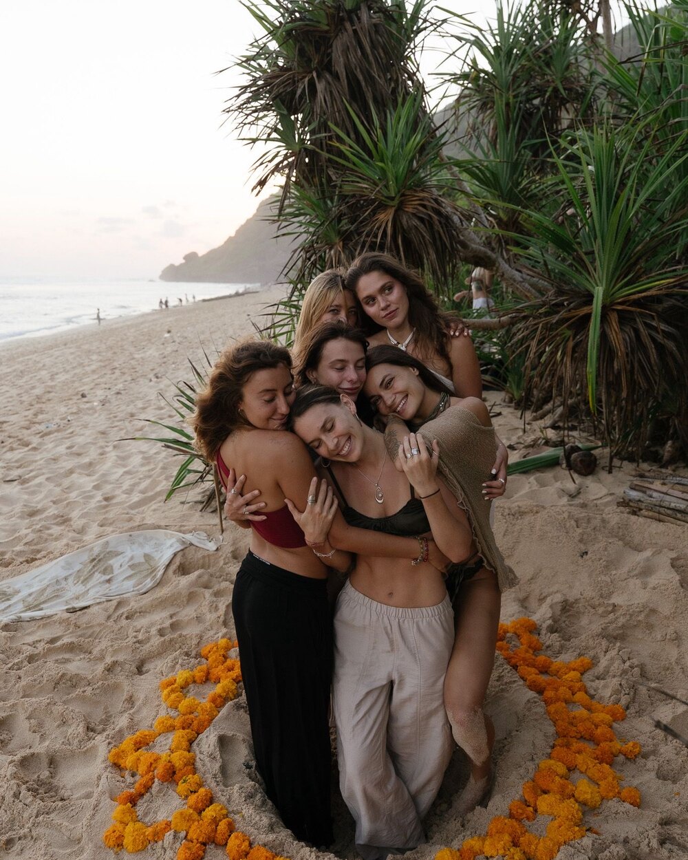 The group together on the beach at sunset